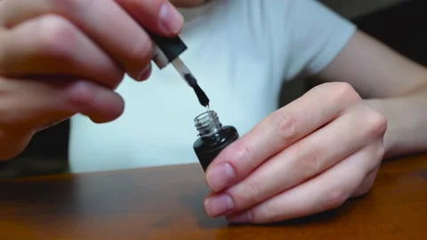 Girl opens nail base, Preparing for manicure, Brush with nail polish Stock Footage 197077452
