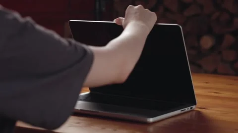 A girl opens a new MacBook Pro 14 inch M4. Stock Footage 313897386