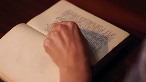 Girl Opens an Old Dictionary Stock Footage 46114363