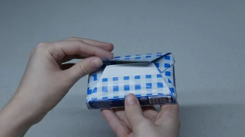 The girl opens a pack of butter Stock Footage 127699593