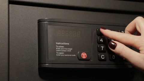 The girl opens a reliable electronic safe Stock Footage 88120882