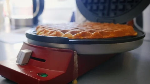 Girl Opens Waffle Iron with a Cooked Golden Brown Waffle Inside in 4k Stock Footage 86484809