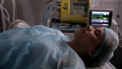 Girl on the operating table. Is preparing for surgery. Video stock 82890997