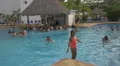 Girl in orange swimsuit and other tourists at Playa Blanca Resort, Panama 4k or 4k+ Resolution