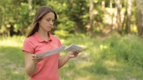 Girl with a package of documents in the park Stock Footage 76166349