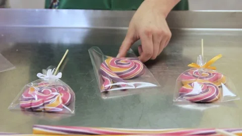 Girl packs caramel candy in a package Stock Footage 91851853