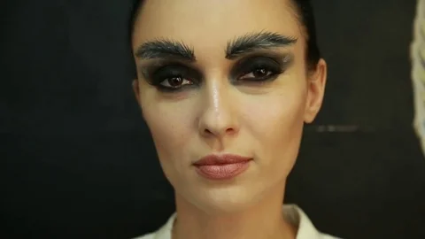 Girl with painted eyebrows looks at the camera Stock Footage 74350029