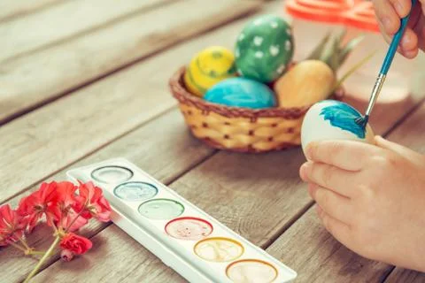 Girl paints Easter egg Stock Photos