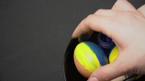 Girl Paints Easter Eggs in Yellow-Blue Color Stock Footage 171474059