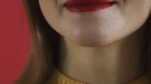 Girl paints her lips close-up Stock Footage