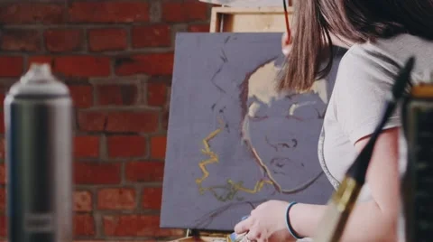 Girl paints paints on canvas slide up Stock Footage 64764053