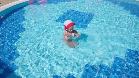 A girl in panama dances in the pool. Stock Footage 252042386