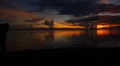 Girl with Pareo Running along the Sea Coast against Fantastic Sunset. Slow HD Footage