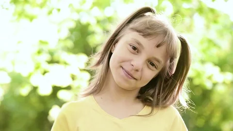Girl in park looking at camera Stock Footage 75392982