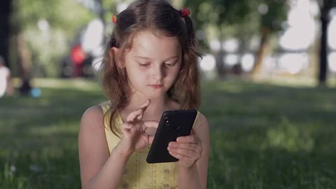 Girl in the park using a smartphone. Stock Footage 109312013