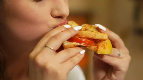 Girl passionately eats and bites a ketchup sandwich. Eat before bedtime. Stock Footage 132710088
