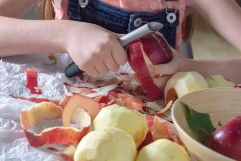Girl peeling apples Stock Photos