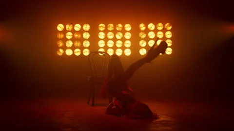 Girl performing gymnastic elements dancing sexy dance near chair nightclub. Stock Footage 182842201