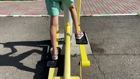 Girl performs exercises on a leg trainer, running and walking, stepper Video stock 158832228