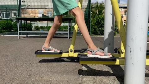 Girl performs exercises on a leg trainer, running and walking, stepper Video stock 158832232