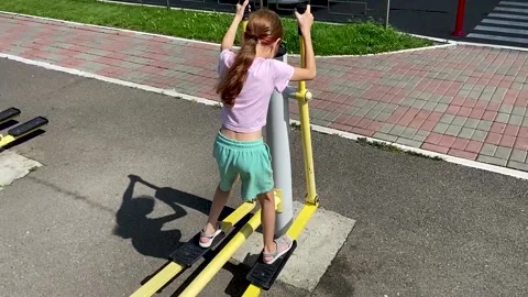 Girl performs exercises on a leg trainer, running and walking, stepper Video stock 158832234