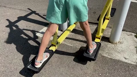Girl performs exercises on a leg trainer, running and walking, stepper Video stock 158927996