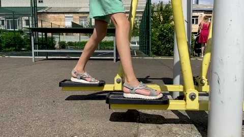 Girl performs exercises on a leg trainer, running and walking, stepper Video stock 158928015