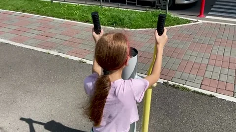 Girl performs exercises on a leg trainer, running and walking Stock Footage 158928018