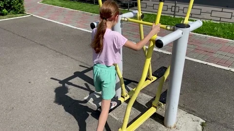 Girl performs exercises on a leg trainer, running and walking, stepper Video stock 160705518