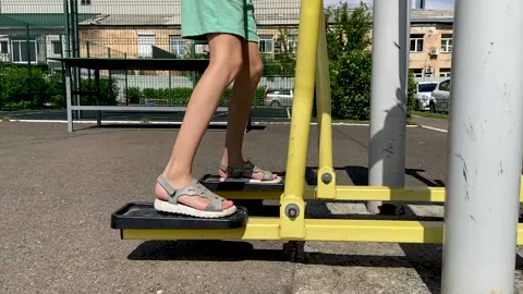 Girl performs exercises on a leg trainer, running and walking, stepper Video stock 160705525