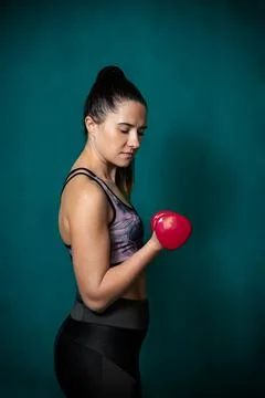 Girl performs exercises using dumbbells. Stock Photos