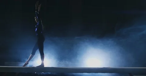 The girl performs a trick on a log in backlight and slow motion in sports Stock Footage 103504738