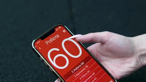 Girl on phone set timer 60 seconds hold phone in hands long manicure getting Stock Footage 316957084