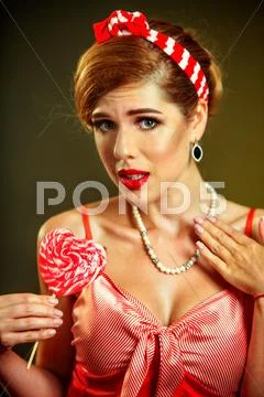 Girl In Pin-Up Style Hold Striped Lollipops.