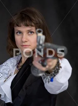 The girl - pirate with ancient pistol in hand Stock Photos