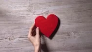 Girl Placing Red Heart On A Wooden Table, Top View. Romance, Love, Valentine's Stock Footage