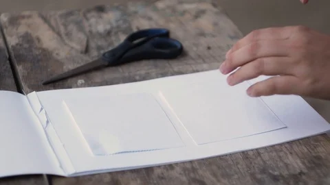 The girl plans a pencil the drawing of a cloud on paper. Stock Footage 102736336