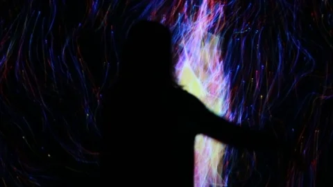 Girl play with interactive video installation Stock Footage