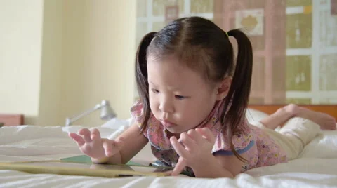 Girl play tablet computer games Stock Footage 67580387
