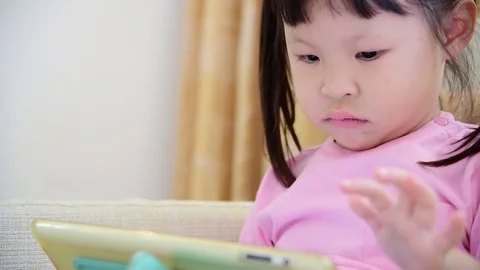 Girl play tablet computer games Stock Footage 74966106