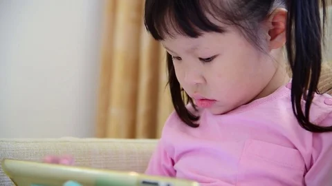Girl play tablet computer games Stock Footage 74989356