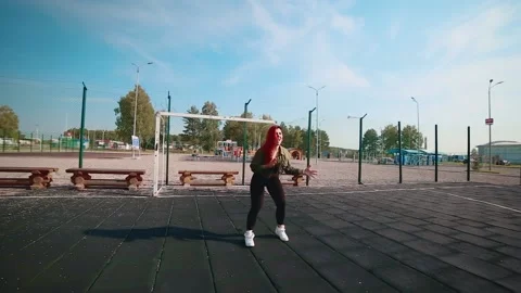 The girl on the playground performs a cool dance. Stock Footage 148472699