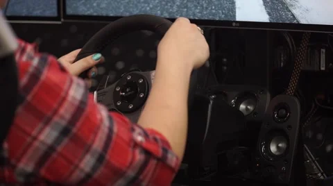 Girl playing auto simulator with virtual reality VR glasses Stock-Footage 68830080