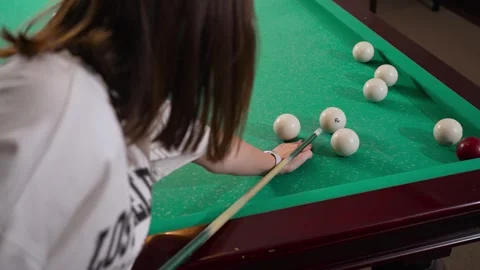 A girl is playing billiards in the billiard room Stock Footage 258271663