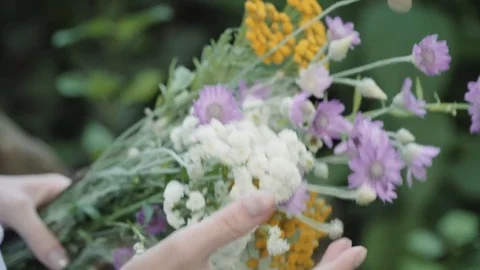 Girl playing with bright summer flowers. Stock Footage 77418853