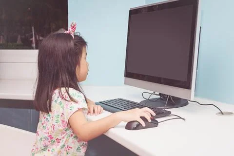 Girl playing with a computer Stock Photos