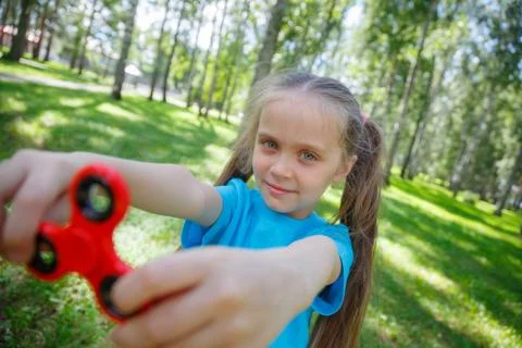 Girl playing with a fidget spinner Stock Photos