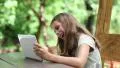 Girl playing the game on his tablet PC HD Footage
