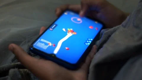 Girl playing game on mobile Stock Footage 164618182