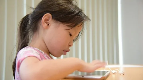 Girl playing games on tablet computer Stock Footage 95505208